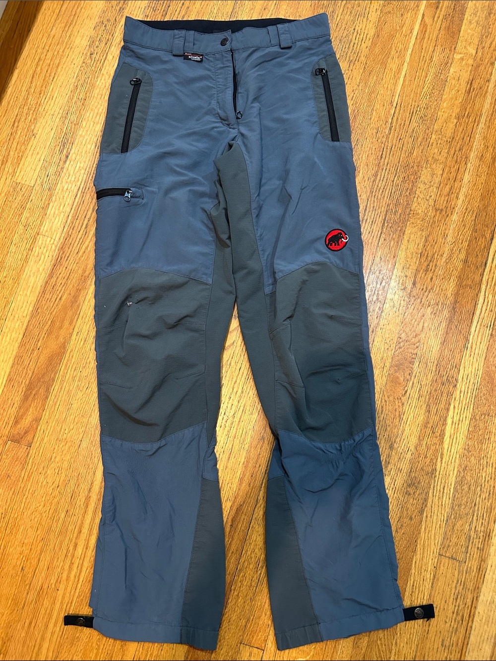 Mammut women’s Slate and Dark Gray Technical Cargo Pants. Size 36. Damage on leg